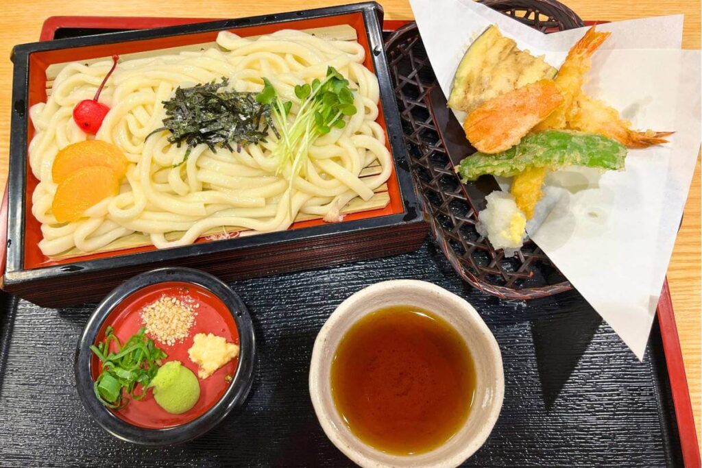 Japanese udon with tempura, spices, and soy sauce