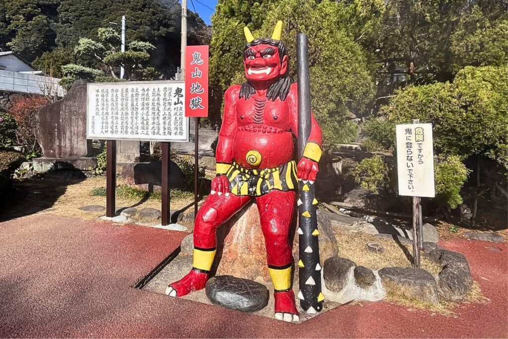 A red devil statue at the 7 Hells of Beppu