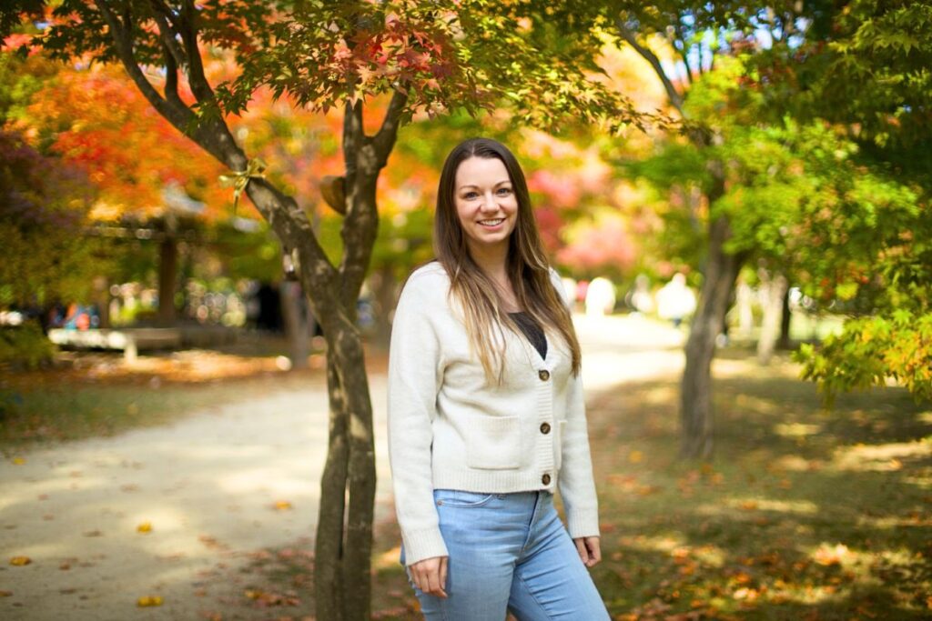Krysti standing in front of autumn foliage at Nami Island.