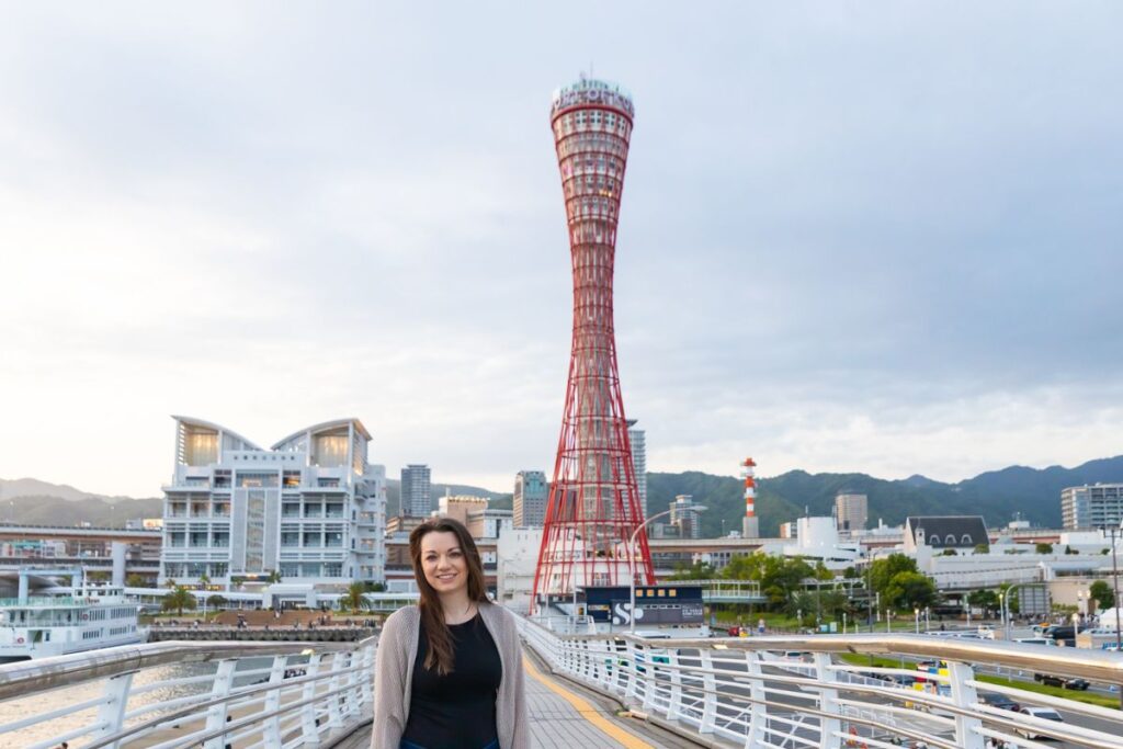 Krysti standing and smiling in front of the red Kobe Port Tower