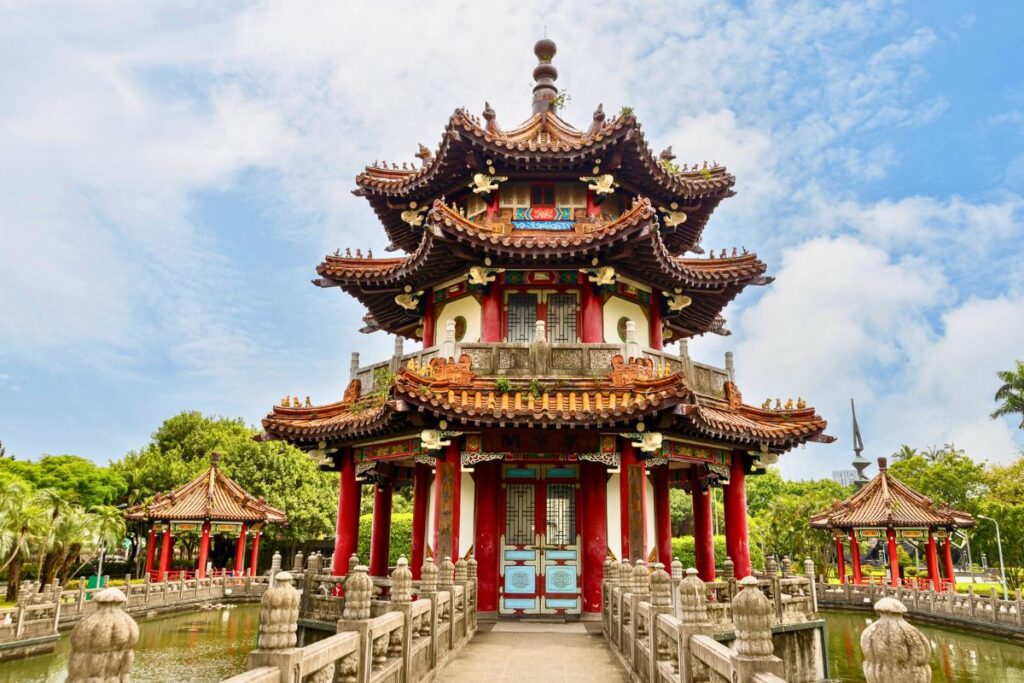 A traditional Chinese pavilion located in the center of a pond.