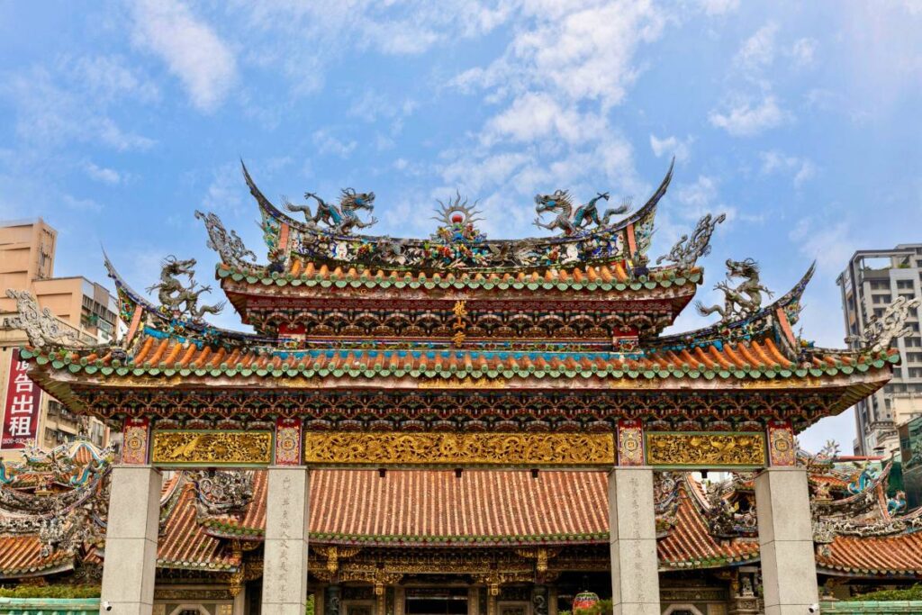 The entrance to Longshan Temple with intricate details and carved dragons.