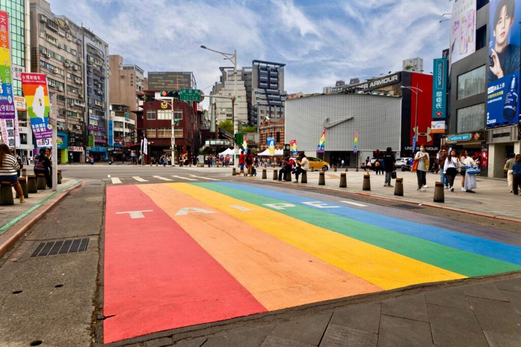 A brightly painted rainbow covering a busy street in Taipei.