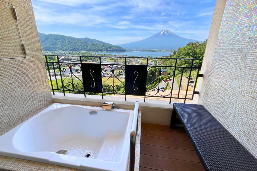 The balcony at La Vista Fujikawaguchiko with an open air bath tub and views of Mount Fuji.