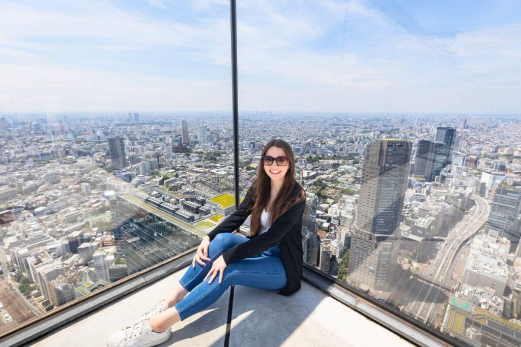 Krysti - Shibuya Sky - Tokyo Krysti posing at Shibuya Sky with views of Tokyo's skyline in the background.