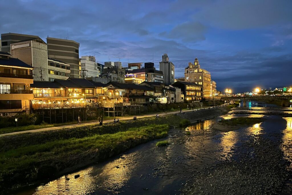 View overlooking Kamo River with riverside restaurants all lit up.