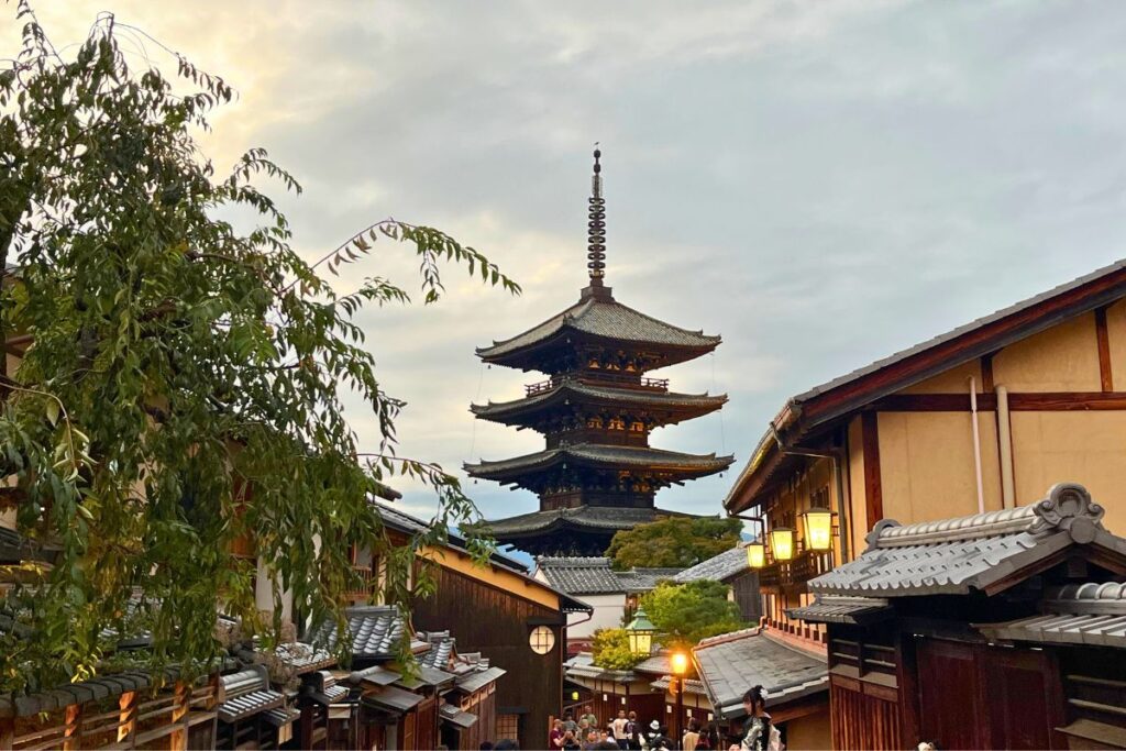 Historic wooden pagoda surrounded by traditional Japanese homes.