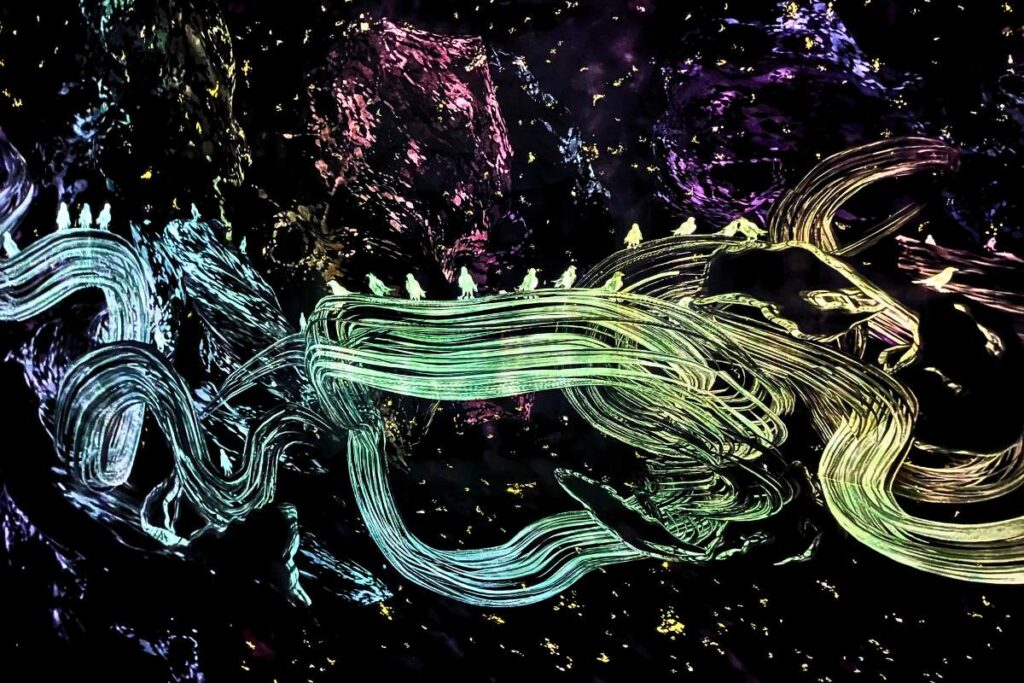 A brightly colored digital projection of swirling lines and birds.