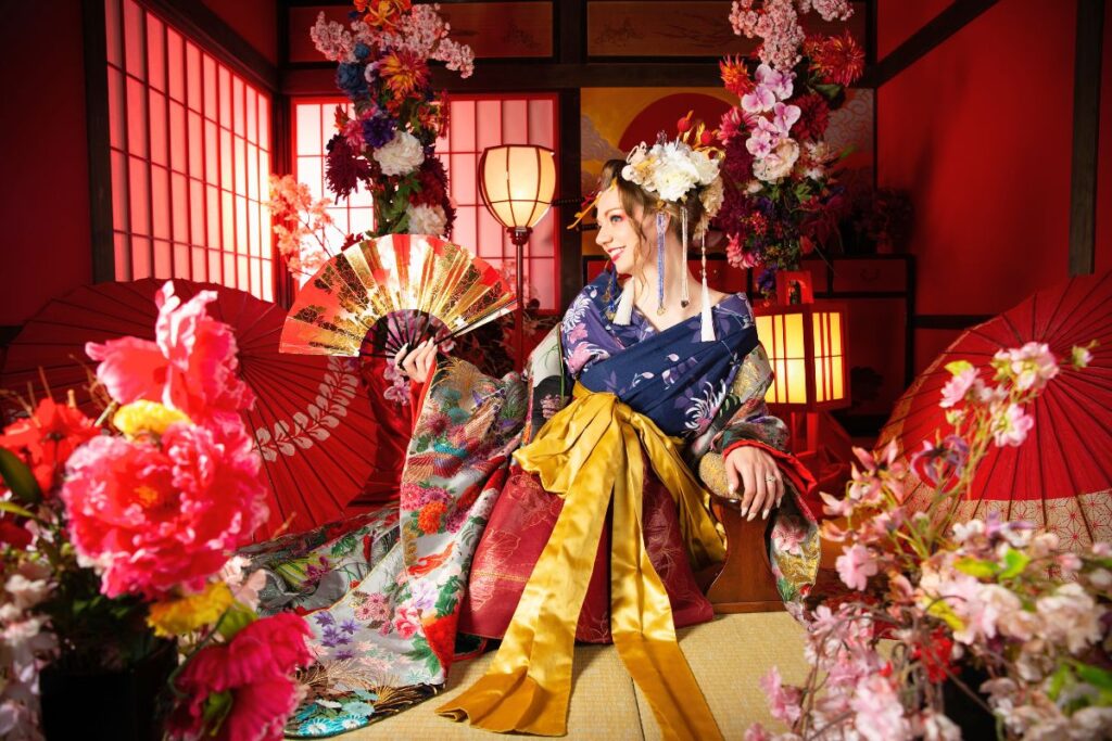 Krysti dressed up in a kimono posing in a studio surrounded by Japanese-inspired decor
