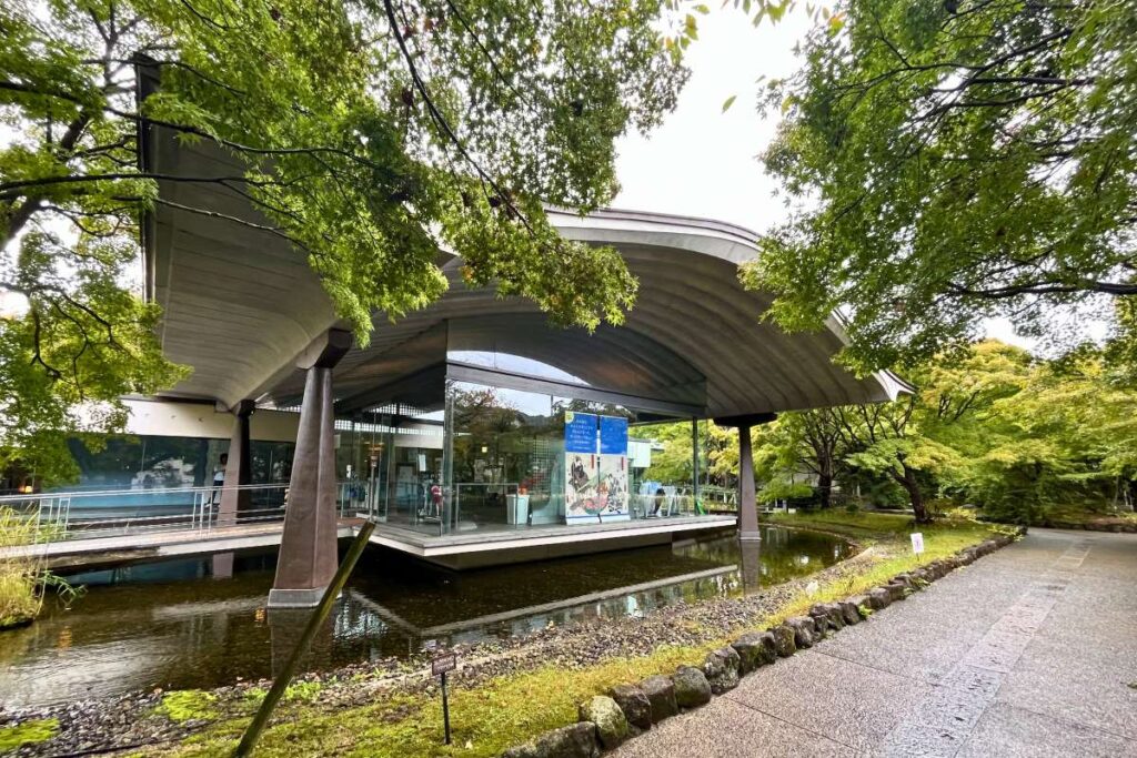 Tale of Genji Museum framed by green trees