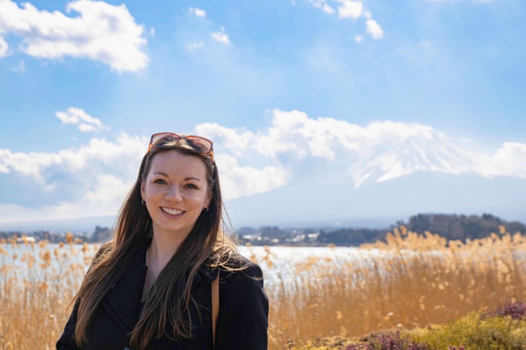 Krysti standing in front of Lake Kawaguchiko with Mt Fuji in the background.