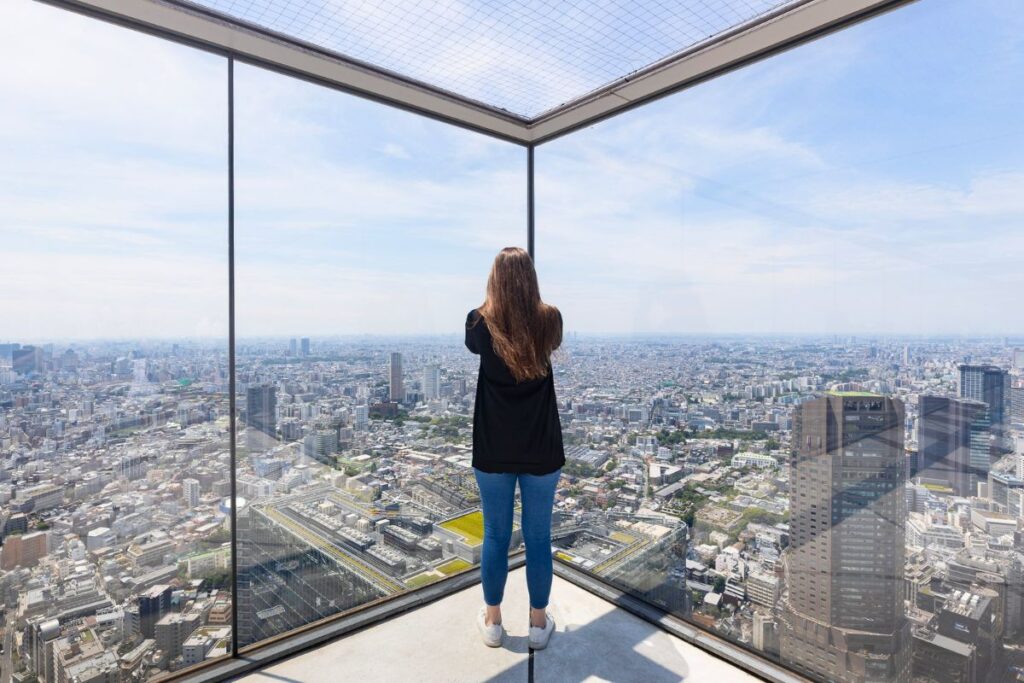 Krysti standing at one of the rooftop corners at Shibuya Sky.