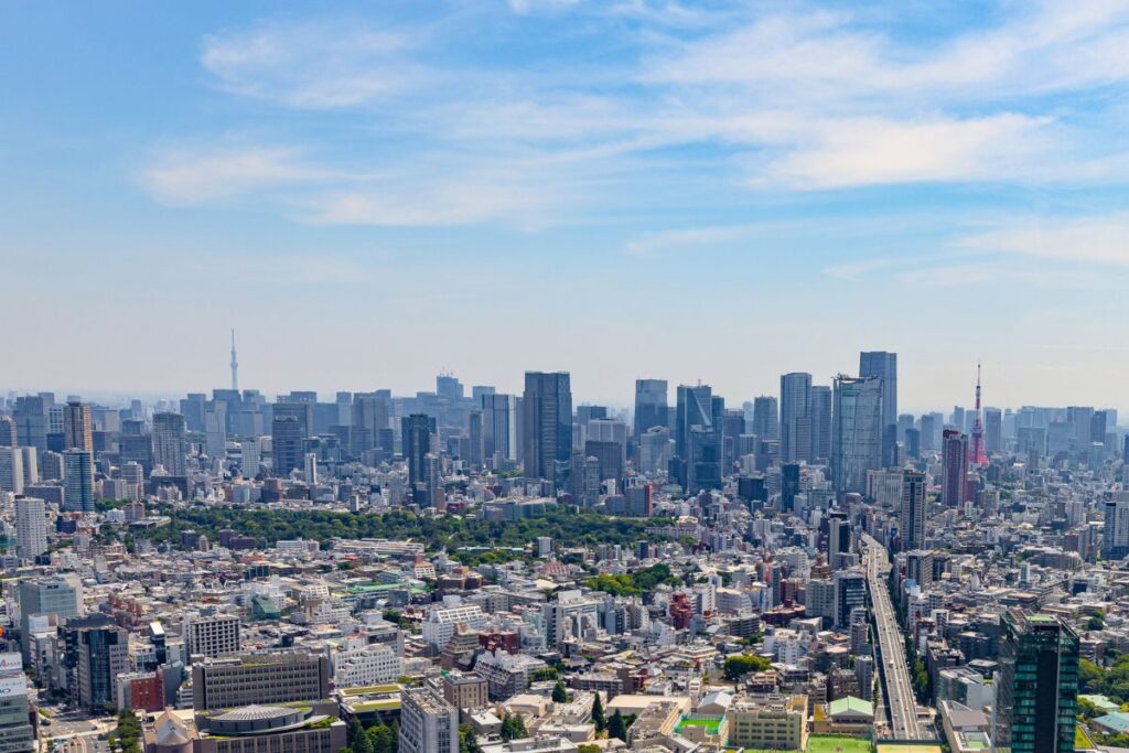 View of the city skyline from Shibuya Sky with Tokyo Tower in the distance.